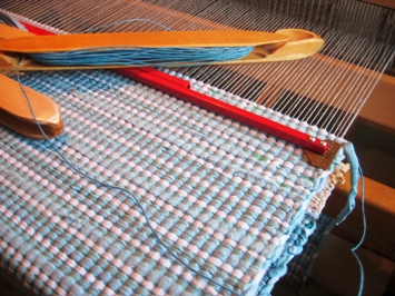 This photo of a rug being woven on a weaving loom was taken by a Finnish photographer.